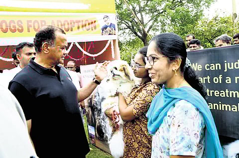 R&B Minister Komatireddy Venkat Reddy interacts with pet lovers at a dog adoption programme in Nalgonda on Saturday.