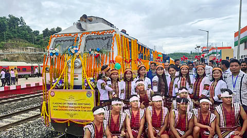 Artistes pose near the Aizawl (Sairang) to New Delhi Rajdhani Express, during its flagging off by Prime Minister Narendra Modi in Aizawl, Mizoram.