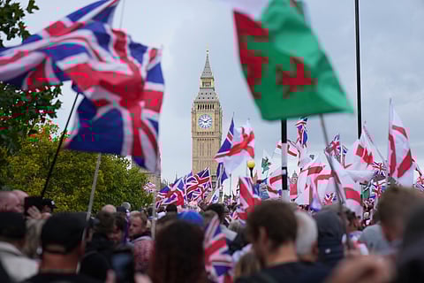Demonstrators take part in the Tommy Robinson-led Unite the Kingdom march and rally near Westminster, London, Saturday, Sept. 13, 2025.