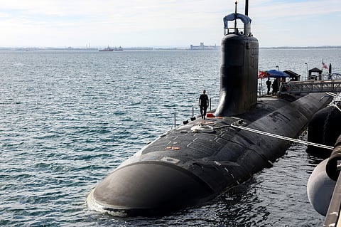 US Navy officers stand aboard the Virginia-class fast-attack submarine USS Minnesota after the vessel docked at HMAS Stirling in Rockingham, Western Australia, on February 26, 2025, during a port visit.