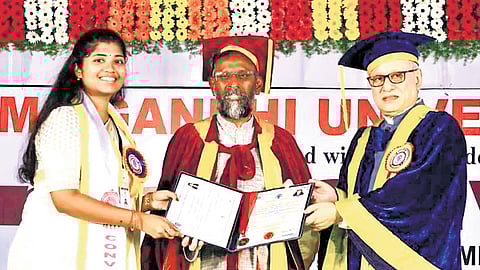 Governor Jishnu Dev Varma, along with IIT-H Director BS Murty, distributes degree certificates during the convocation ceremony at MG University, Nalgonda, on Monday.