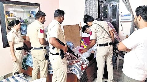 Police officials carry out raids at a residential premises in Delhi.