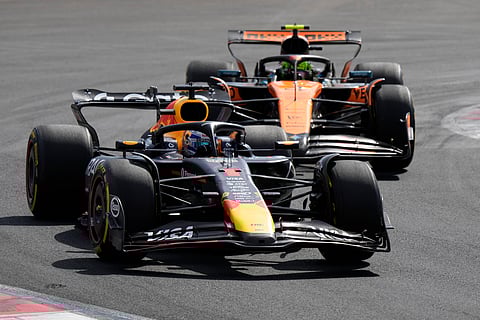 Red Bull driver Max Verstappen of the Netherlands steers his car in front of McLaren driver Lando Norris of Britain during the Italian Grand Prix race at the Monza racetrack in Monza, Italy, Sunday, Sept. 7, 2025.