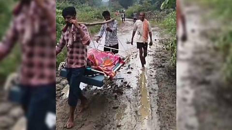 A woman being carried on a makeshift stretcher in Cherla mandal, Bhadradri Kothagudem district, on Tuesday.