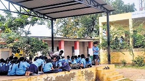 The crumbling wall of Yattinabudihal Government School in Ballari district has resulted in classes being held out in the open.