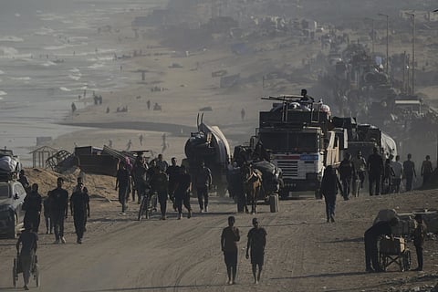 Displaced Palestinians flee Gaza City by foot and vehicles, carrying their belongings along the coastal road toward southern Gaza, Wednesday, Sept. 17, 2025.