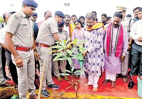 Union Minister Dharmendra Pradhan watering a plant in Sambalpur on Wednesday