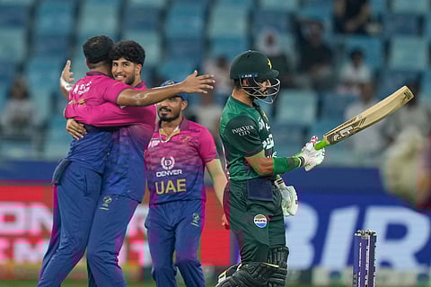 UAE's Junaid Siddique, left, celebrates the dismissal of Pakistan's Sahibzada Farhan with teammates during the Asia Cup cricket match between Pakistan and United Arab Emirates on Wednesday, Sept. 17, 2025.