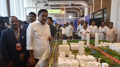 Vijayawada MP Kesineni Sivanath takes a look at the miniature models of future government complexes at the NAREDCO property expo in Vijayawada on Friday.
