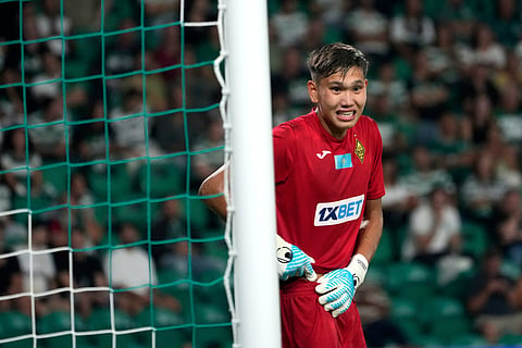 Kairat's 18-year-old goalkeeper Sherhan Kalmurza looks on during the Champions League opening phase soccer match between Sporting CP and Kairat Almaty at the Alvalade stadium in Lisbon, Thursday, Sept. 18, 2025.