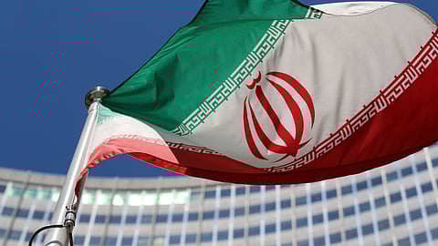 FILE - The Iranian flag flies in front of a U.N. building where closed-door nuclear talks take place at the International Center in Vienna, Austria, on June 18, 2014.