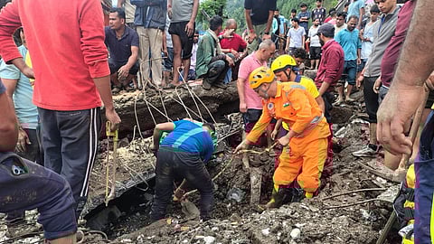 Rescue teams searching for survivors through debris after Chamoli cloubburst disaster.