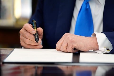 US President Donald Trump signs an executive order in the Oval Office of the White House, Monday, Sept. 20, 2025, in Washington.