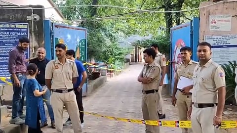 Police personnel keep vigil outside Sarvodaya (Co-Ed) Senior Secondary school after it received a bomb threat, at Mehrauli, in New Delhi, Saturday,