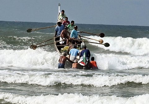 Fishermen from Kovalam braving the waves to venture into the deep sea for fishing.