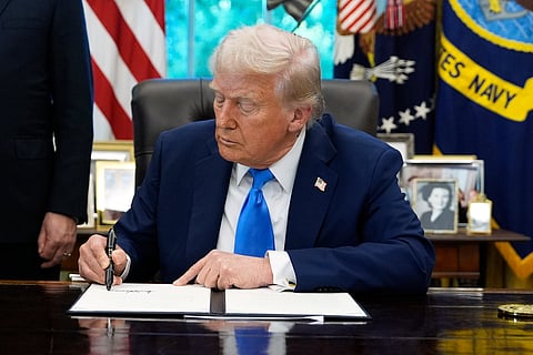 President Donald Trump signs the Gold Card executive order in the Oval Office of the White House, Friday, Sept. 19, 2025, in Washington.