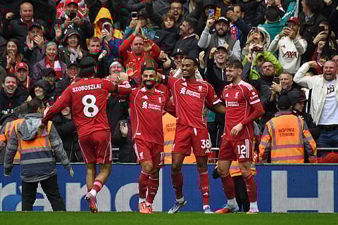 Liverpool's Ryan Gravenberch, second right, celebrates with teammates after scoring his side's opening goal during the English Premier League match against Everton at Anfield (Photo | AP)