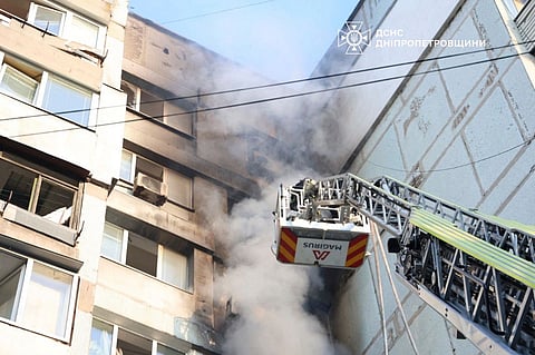 In this photo provided by the Ukrainian Emergency Services on Saturday, Sept. 20, 2025, a rescue worker puts out a fire of a residential house damaged by a Russian strike on Dnipro, Ukraine.