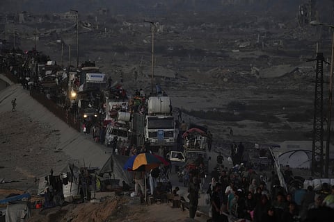Displaced Palestinians flee Gaza City, by foot and vehicles, carrying their belongings along the coastal road in Nuseirat toward the southern Gaza Strip, Friday, Sept. 19, 2025.