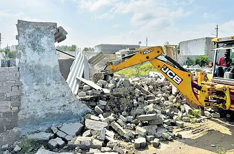 A JCB carries out an anti-encroachment drive in Gajularamaram on Sunday.