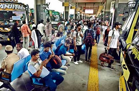 Public waiting to board the bus to visit their respective hometowns at Kilambakkam bus terminus.