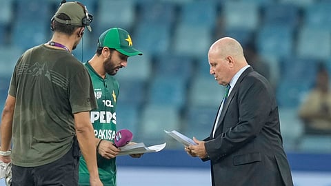 Pakistan's captain Salman Agha shares team list with match referee Andy Pycroft at the toss during the Asia Cup cricket match between Pakistan and United Arab Emirates on Sept. 17, 2025.