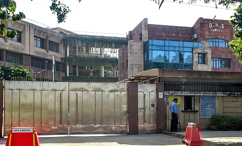 A security guard keeps vigil outside Delhi Public School, Dwarka, after it received a bomb threat, in New Delhi, Saturday, Sept. 20, 2025. Multiple schools in the national capital received bomb threats on Saturday morning.