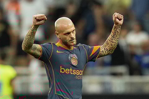 Inter Milan's Federico Dimarco celebrates after he scored his side's first goal during a Serie A soccer match between Inter Milan and Sassuolo, at San Siro stadium in Milan, Italy, Sunday, Sept. 21, 2025.