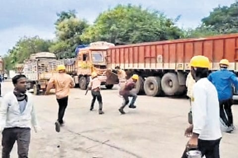 Migrant wokers hurl stones at police during a protest at Deccan Cement factory in Palakeedu mandal, Nalgonda district on Monday