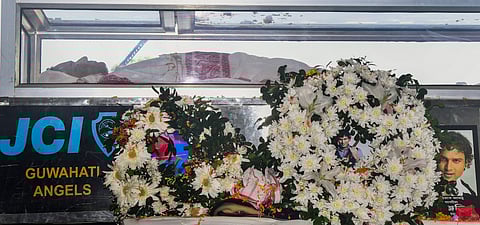Mortal remains of Assam's cultural icon and singer Zubeen Garg are seen kept in a glass casket draped with a traditional Assamese gamosa, at Sarusajai stadium, in Guwahati, Monday, Sept. 22, 2025.