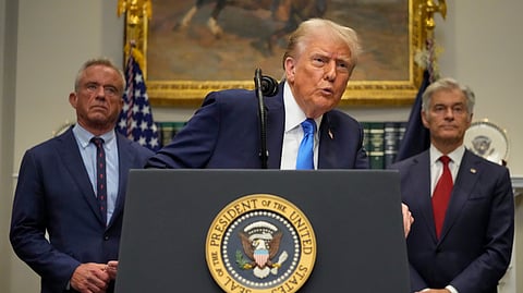 US President Donald Trump speaks in the Roosevelt Room of the White House, Monday, Sept. 22, 2025, in Washington, as Health and Human Services Secretary Robert F Kennedy Jr, left, and Centres for Medicare & Medicaid Services administrator Dr Mehmet Oz listen.