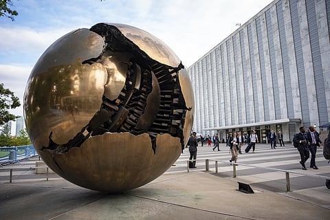 People walk around the plaza by the Sphere within Sphere outside the United Nations Headquarters on the first day of the 80th session of the UN General Assembly's High-Level week, Monday, September, 22, 2025.