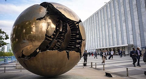 People walk around the plaza by the Sphere Within Sphere outside the United Nations Headquarters on the first day of the 80th session of the UN General Assembly's High-Level week, Monday, Sept. 22, 2025.