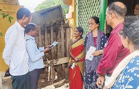 Officials interact with a family during the caste census in Hubballi on Tuesday.