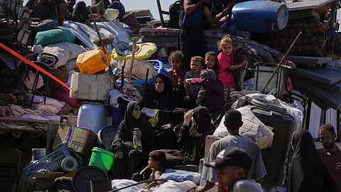 Displaced Palestinians flee Gaza City by foot and vehicles, carrying their belongings along the coastal road toward southern Gaza, Wednesday, Sept. 17, 2025.
