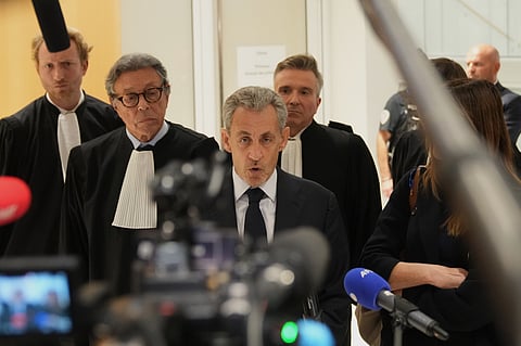 Former French President Nicolas Sarkozy speaks to the media as he leaves the courthouse, in Paris, France, Thursday, Sept. 25, 2025.