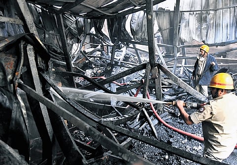 Fire personnel put out the fire that broke out at a handicraft store on Pipeline Road early on Friday.