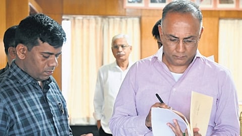 Health Minister Dinesh Gundu Rao prepares to address the media on maternal mortality, at Vikasa Soudha on Friday.