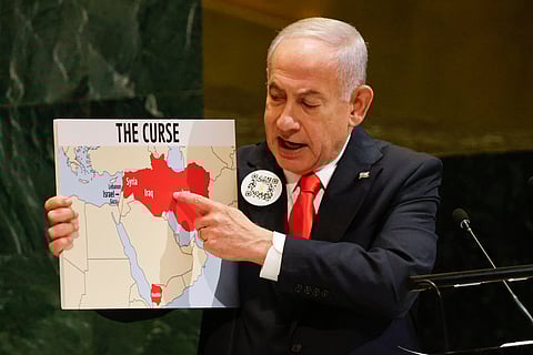 Israeli Prime Minister Benjamin Netanyahu holds up a map while speaking at the 80th session of the United Nations General Assembly, Friday, Sept. 26, 2025, at U.N. headquarters.