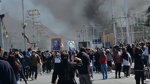 In this photo from Sept. 24, 2025, smoke rises from buildings including the local office of the BJP set ablaze during protests in Leh town.