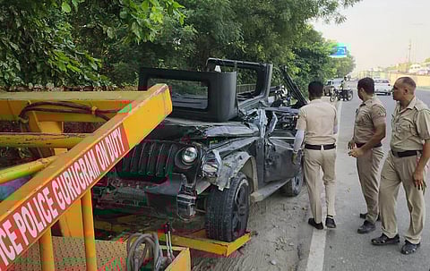 Police personnel look on as wreckage of a Thar being towed away after an accident, in Gurugram, Saturday, Sept. 27, 2025.