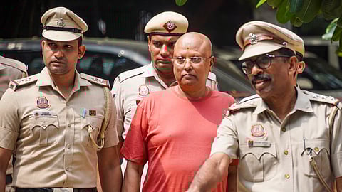 Self-styled godman Chaitanyananda Saraswati, who allegedly sexually harassed 17 women students at a private institute in Agra, being escorted by police personnel after his arrest, at Vasant Kunj police station, in New Delhi, Sunday, Sept. 28, 2025.