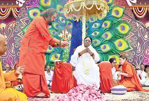 Swami Amritaswarupananda Puri performs arati to Mata Amritanandamayi during her 72nd birthday celebrations at Amritapuri in Kollam on Saturday.