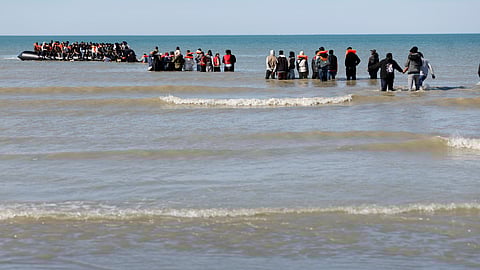 Migrants board a small boat to reach Britain, in Gravelines, northern France, France, Friday, Sept. 19, 2025.