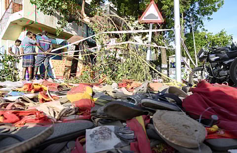 Party flag and chappels remain after the rampage at TVK leader campaign rally in Karur on Sunday