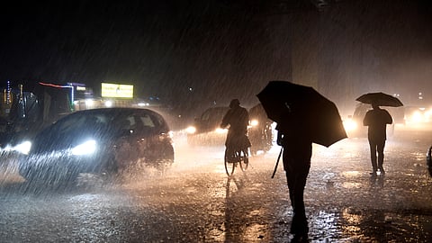 Commuters move amid heavy rainfall, in Mumbai, Maharashtra, late Saturday, Sept. 27, 2025.