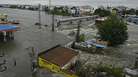 The Musi river flows in spate through the under-construction Moosarambagh bridge after heavy rainfall, in Hyderabad on September 27, 2025