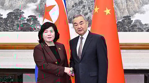 In this photo released by Xinhua News Agency, Chinese Foreign Minister Wang Yi, right, shakes hands with visiting North Korean counterpart Choe Son Hui prior to a meeting, in Beijing on Sunday, Sept. 28, 2025.