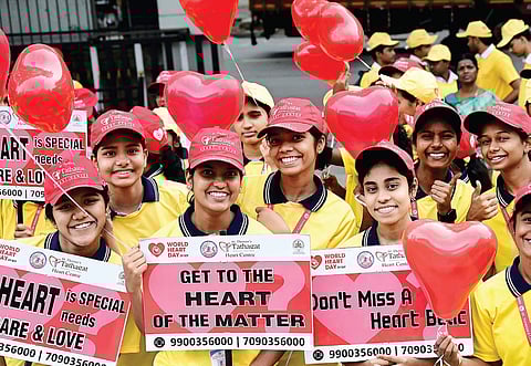 Staff of St Theresa’s Tathagat hospital and volunteers during a marathon to create awareness on heart health to mark the World Heart Day in Bengaluru on Monday.