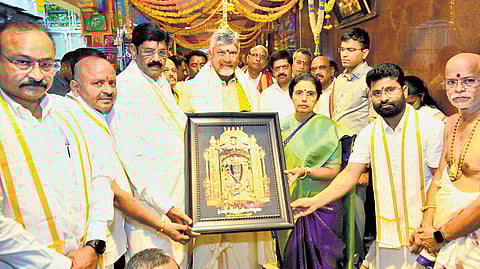 Endowments Minister Anam Ramanarayana Reddy presents a portrait of Goddess Durga to CM Nara Chandrababu Naidu and his wife Bhuvaneswari